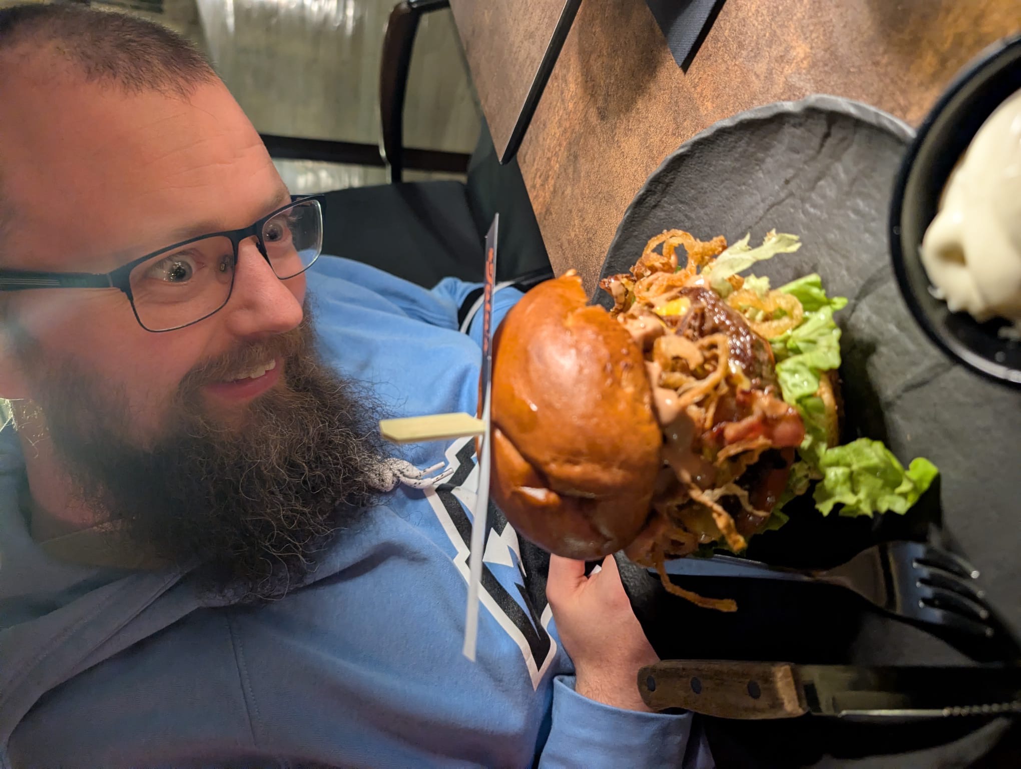 Farrell inspecting a very large burger